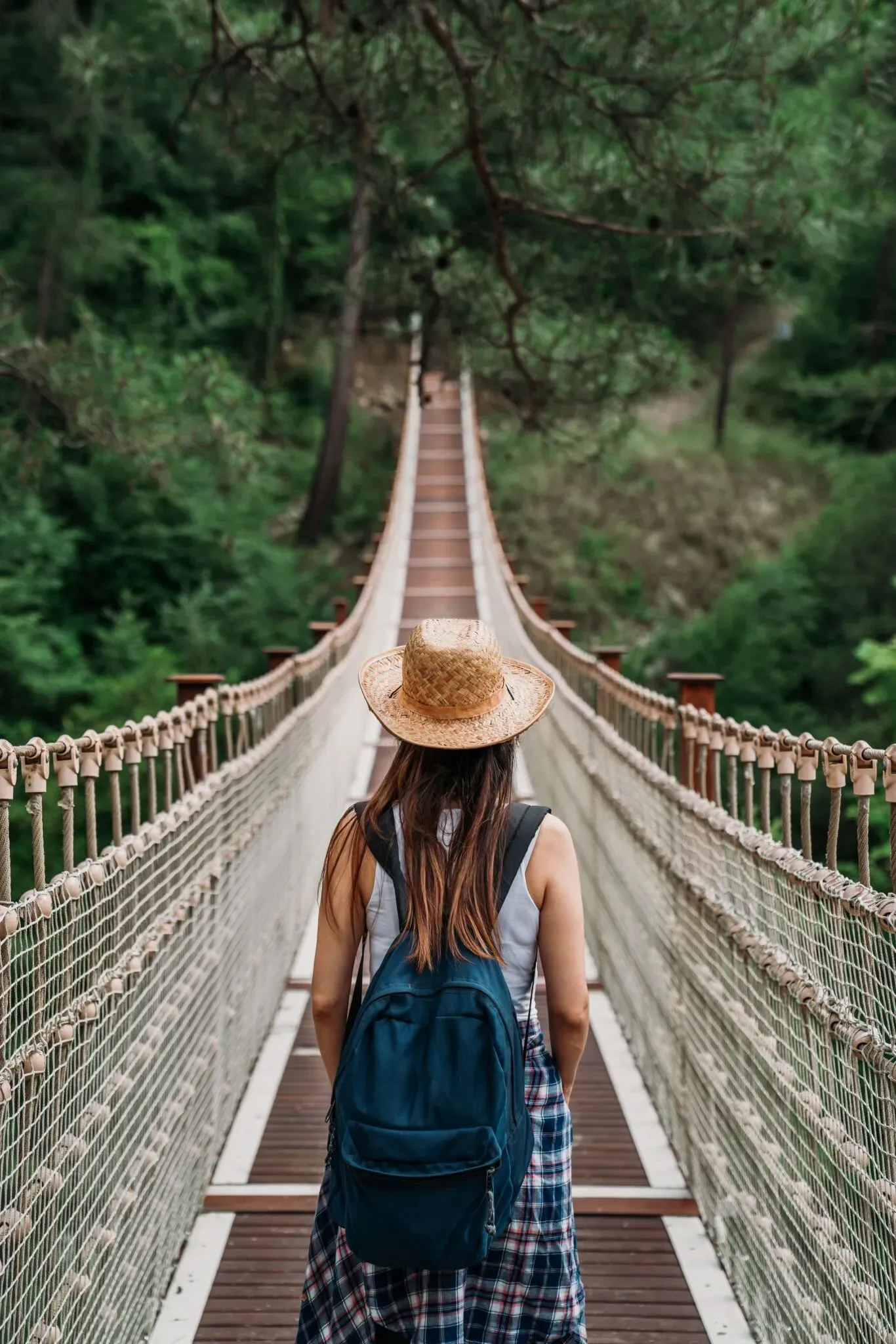 Solo female traveller walking on a bridge in Phitsanulok