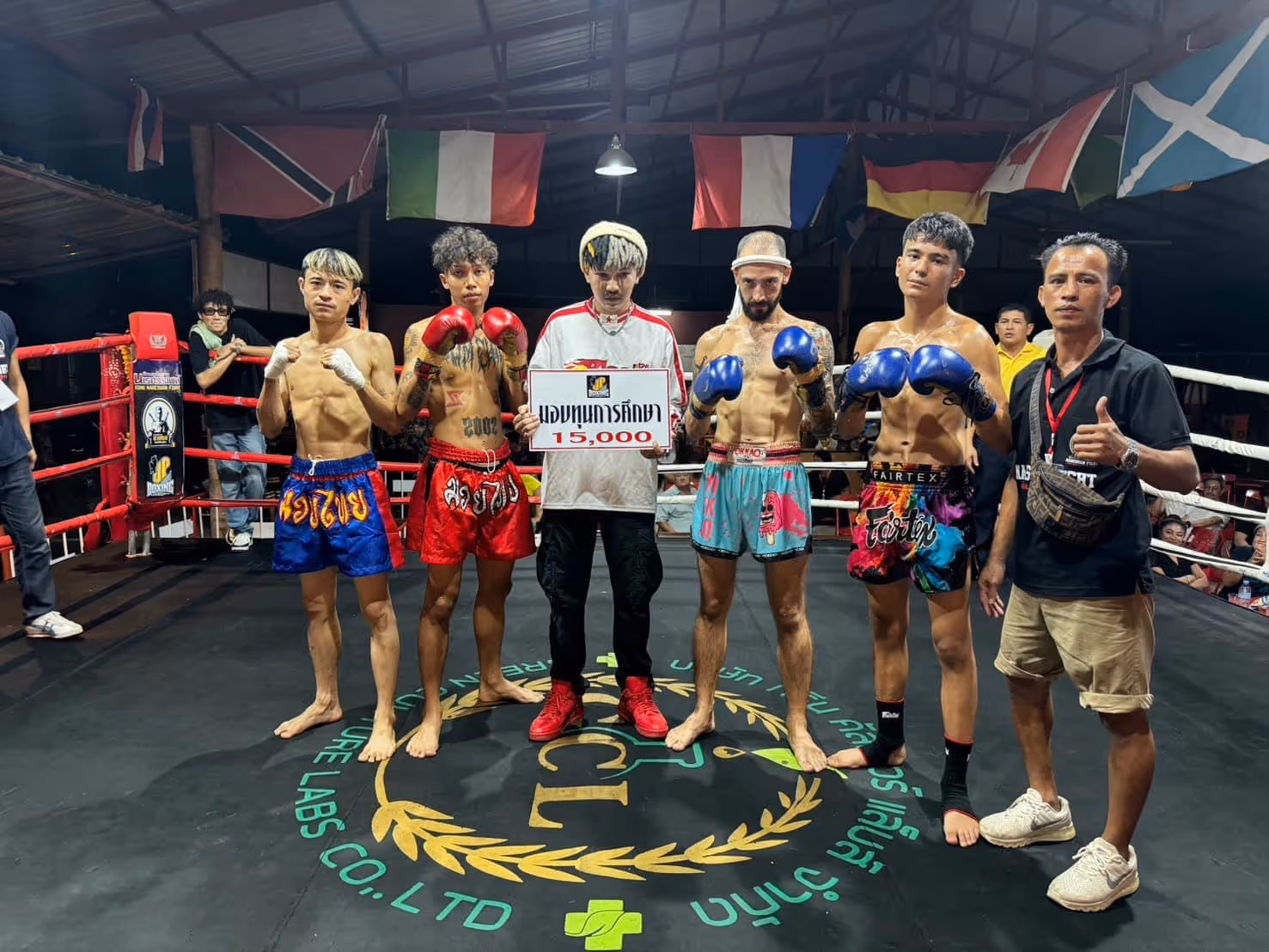 Presenting 15,000 Baht charity prize in the ring