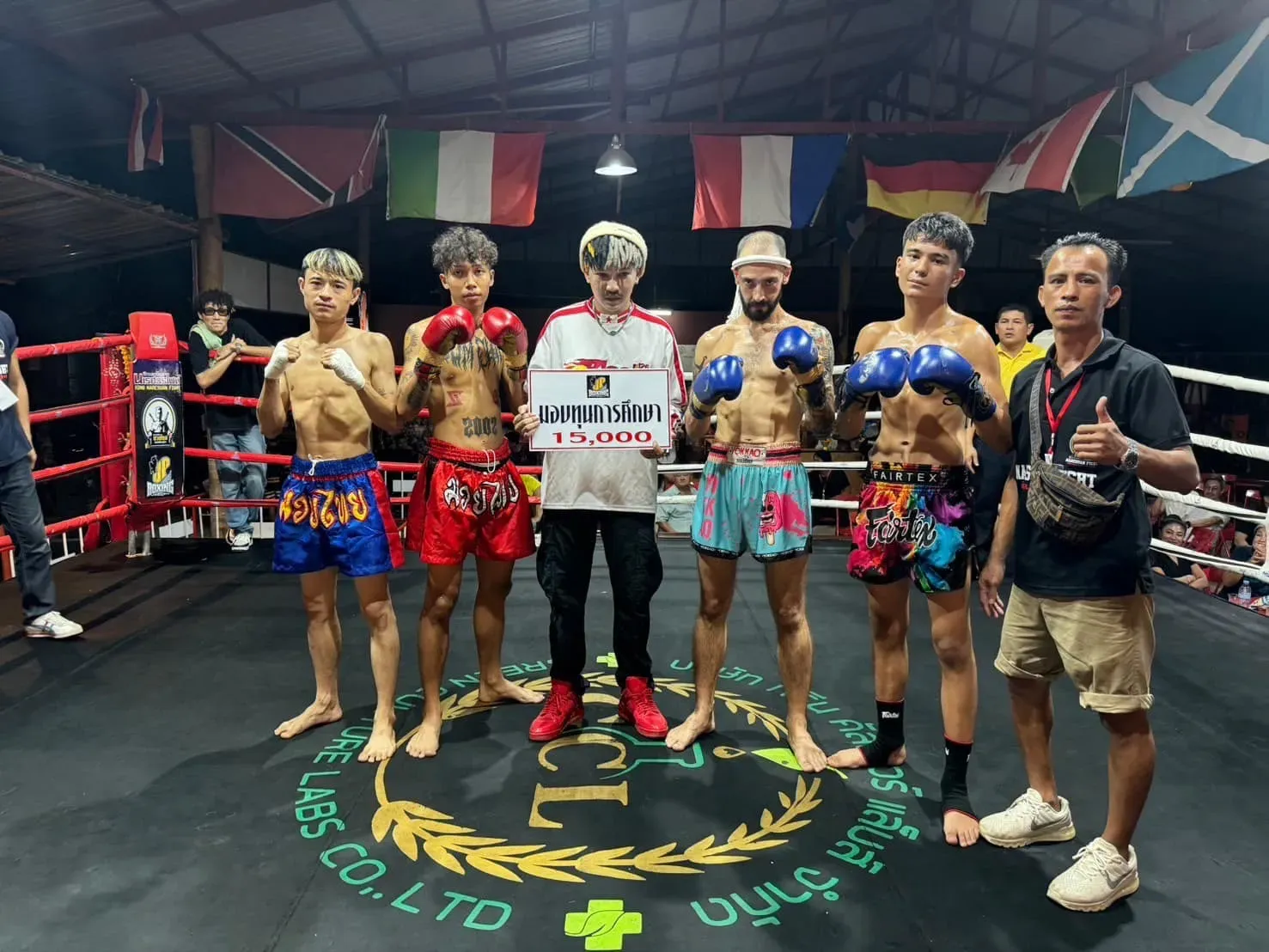 Presenting 15,000 Baht charity prize in the ring