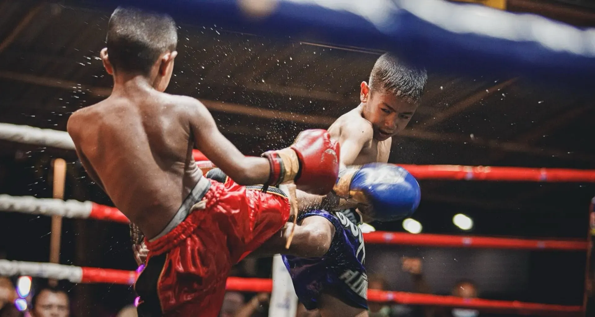 Two kids competing in a Muay Thai charity fight