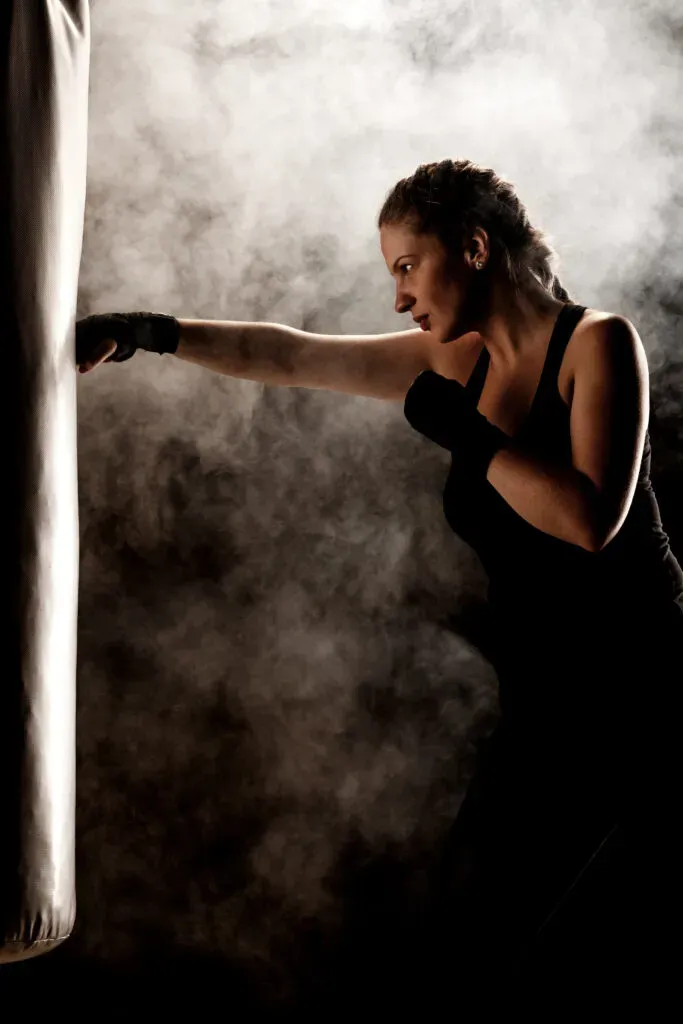 Solo female traveller practicing punches on a heavy bag