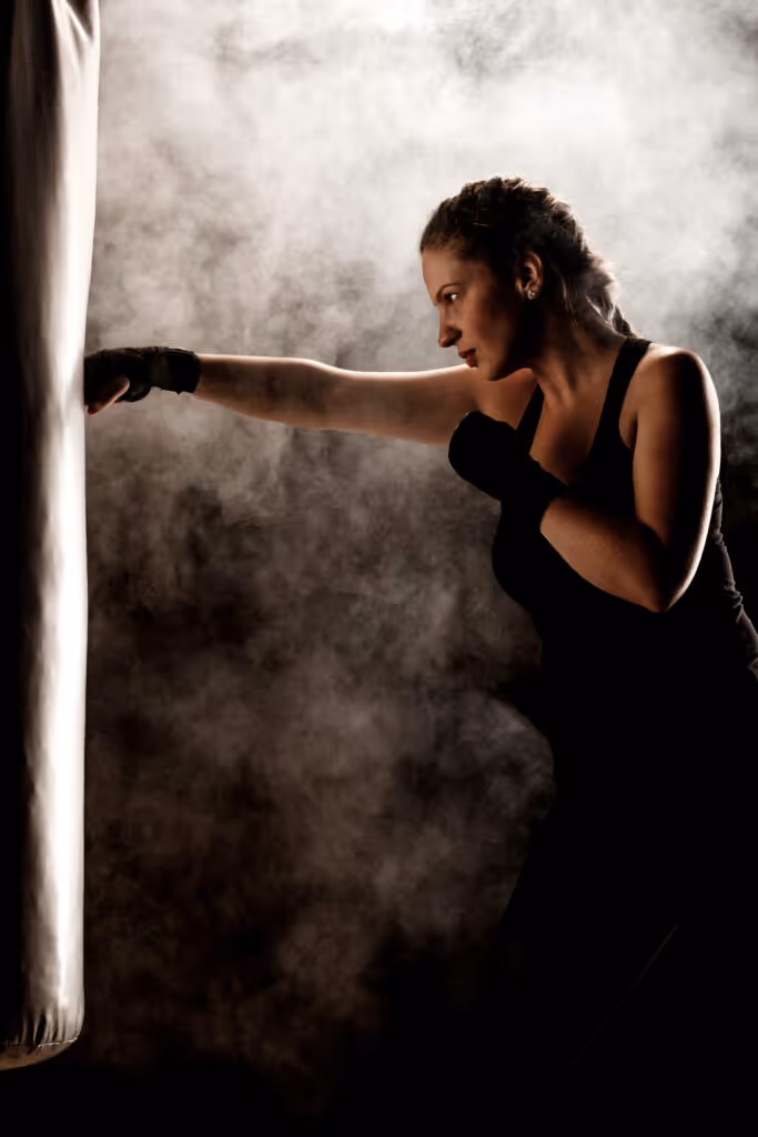 Solo female traveller practicing punches on a heavy bag