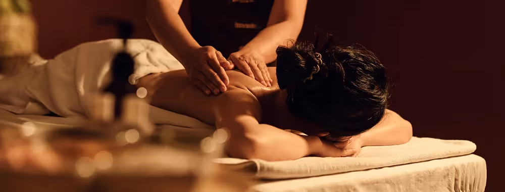 Traditional Thai massage therapist performing therapeutic muscle stretching