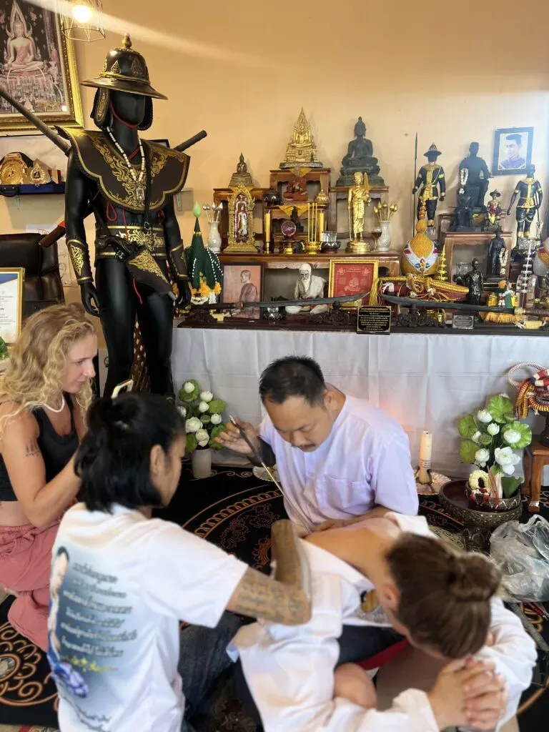 Ajarn performing sacred Sak Yant tattooing ceremony
